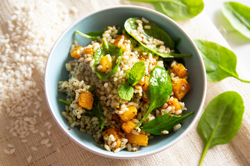 Delicious rice salad with pumpkin and spinach