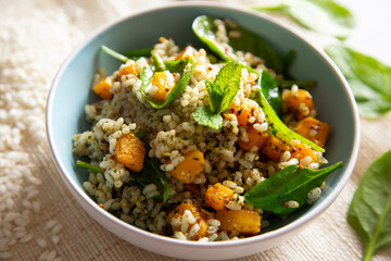 Delicious rice salad with pumpkin and spinach