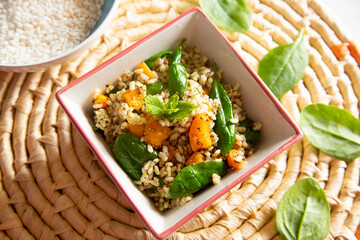 Delicious rice salad with pumpkin and spinach