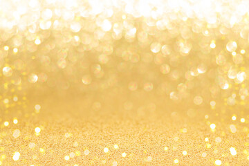 Golden sparkling background with shiny blurred round bokeh.