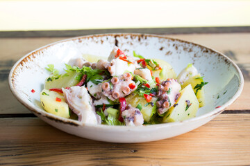 Delicious salad with boiled potato and octopus.