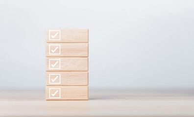 wooden block showing check mark Checklist ideas in business surveys and questionnaires copy space