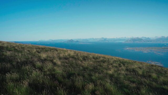 Blowing Wind On Grass Mountain Landscape At Lovund Island, Norway. Wide Shot