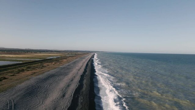 Experience the secluded beauty of Waimate's rocky beach in stunning golden hour light, aerial dolly-out