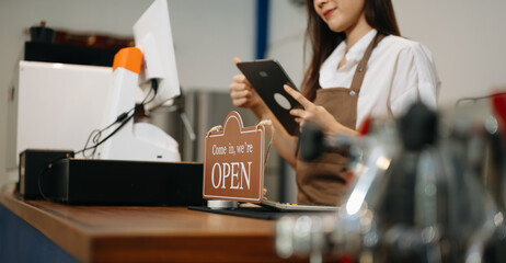 Asian female coffee shop owner in a coffee shop.