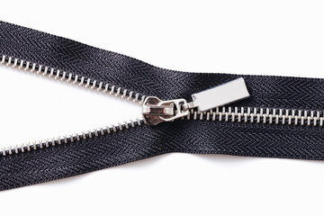 Metal zipper isolated on white. Tailoring object. Clothing part element. Object cutout on white. Fastener fashion background. Zipped part. Garment sewing zipper. Black color.