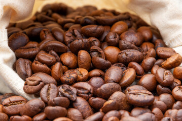Roasted coffee beans and sack bag background. Selective focus, Dark and Moody wallpaper.