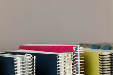 Still life of spiral notebooks against grey background
