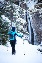 Hiking woman on mountain waterfall background