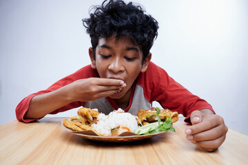 Child having Fried Chicken and rice for lunch