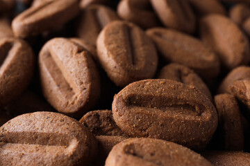Concept of tasty snack for hot drink - cookies in the shape of coffee seeds