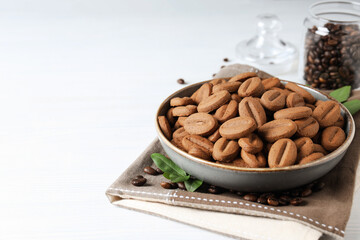 Concept of tasty snack for hot drink - cookies in the shape of coffee seeds