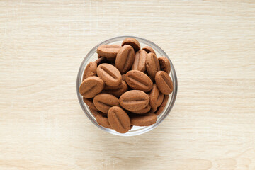 Concept of tasty snack for hot drink - cookies in the shape of coffee seeds