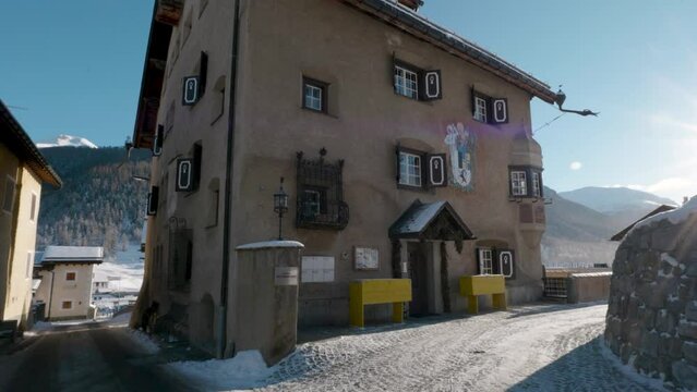 View of a traditional Swiss village  on a sunny winter day in Zuoz, Switzerland.