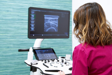 Doctor consulting something on ultrasound equipment while working in a medical center. Concept of...