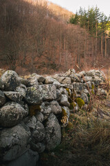 Beautiful morning scenery with a big stone wall in the foreground.