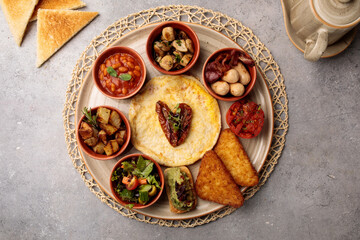 Spanish Breakfast with bread, beans, salad and fish served in dish isolated on table top view of arabic breakfast