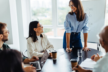 Mature business woman having a discussion with her team in a meeting