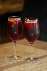 Cold spanish sangria in two transparent glasses on the table in the restaurant.