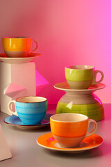 Colorful clay ceramic cups on gray background