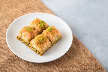 Pistachio Turkish baklava on a white plate,top view
