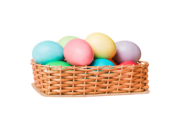 Obraz na płótnie Canvas Basket of colorful Easter eggs isolated on white background. Easter basket filled with colored eggs top view holiday concept