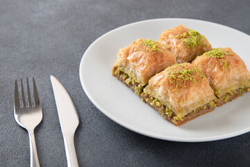 Pistachio Turkish baklava on a white plate.Traditional delicious Turkish baklava
