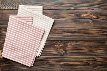 top view with red empty kitchen napkin isolated on table background. Folded cloth for mockup with copy space, Flat lay. Minimal style