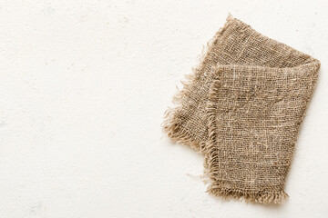 Old burlap fabric napkin, sackcloth on table background. top view with copy space