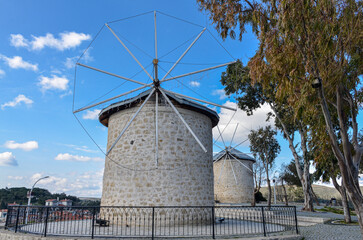 Fototapeta na wymiar old stone windmills in town center of Alacati (Cesme, Izmir region, Turkey)
