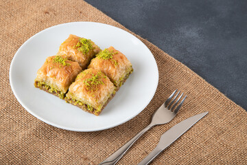 Pistachio Turkish baklava on a white plate,top view

