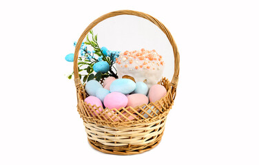 Fototapeta na wymiar Delicious Easter cakes and eggs in a basket on a white background.