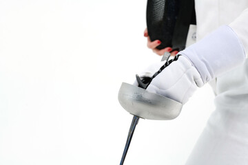 Close-up of a sword in the hands of a female fencer