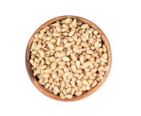 Top view of shelled pine nuts in a wooden bowl.