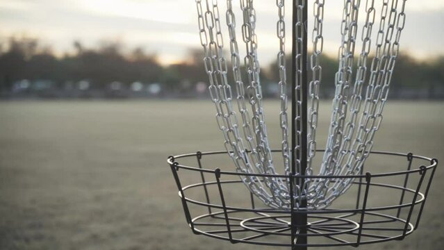 Disc Golf Basket in an Open Field Background