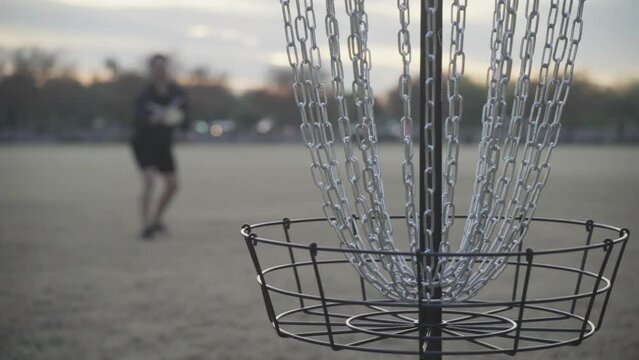 Disc Golf Putt into Disc Golf Basket in Slow Motion
