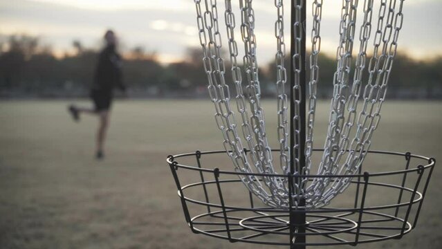 Missed Disc Golf Putt That Hits the Chains and Hits Rim of the Disc Golf Basket Cage