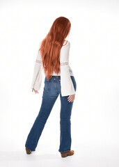 Obraz premium full length portrait of beautiful woman model with long red hair, wearing casual outfit white blouse top and denim jeans, isolated on white studio background. Backwards standing pose, walking away fr