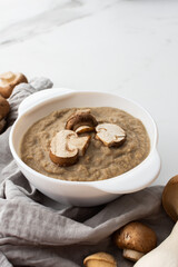 Mushroom cream soup in a plate, delicious healthy soup with Eringi and Champignons, fresh mushrooms...