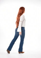 Obraz premium full length portrait of beautiful woman model with long red hair, wearing casual outfit white blouse top and denim jeans, isolated on white studio background. Backwards standing pose, walking away fr