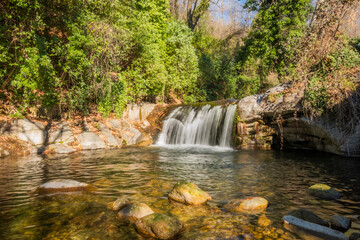 Water flowing over rocks in waterfall cascade in a forest