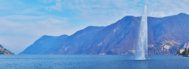 Panorama of Lake Lugano with fountain and Alps in background, Lugano, Switzerland