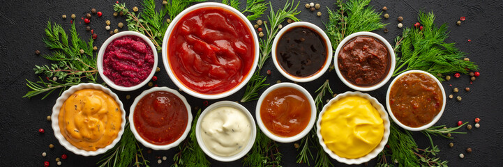 Different types of sauces in bowls with seasonings banner, rosemary and dill, thyme and and peppercorns, top view, copy space - obrazy, fototapety, plakaty