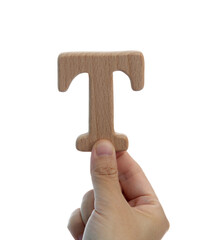 Hand holding wooden letter T