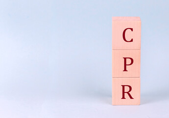 CPR on wooden cubes on a blue background