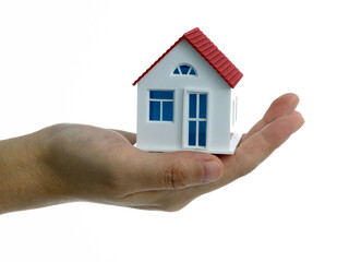 Human hand holding model house