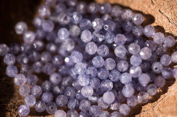 The photo with tanzanite stones is made on the background of a wooden board and dried hydrangea.