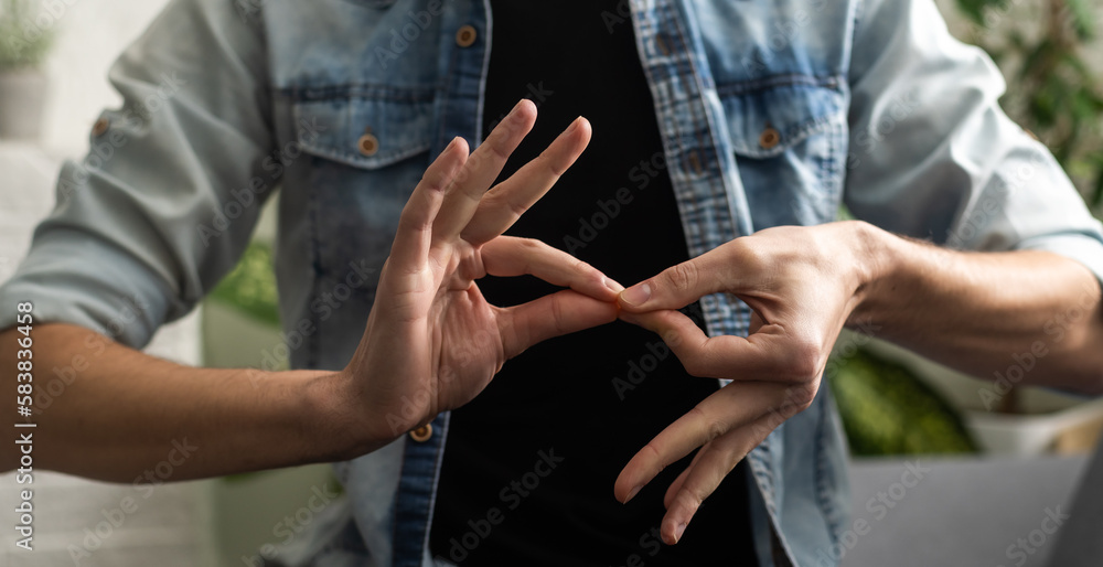 Wall mural sign language interpreter man translating a meeting to asl, american sign language. empty copy space