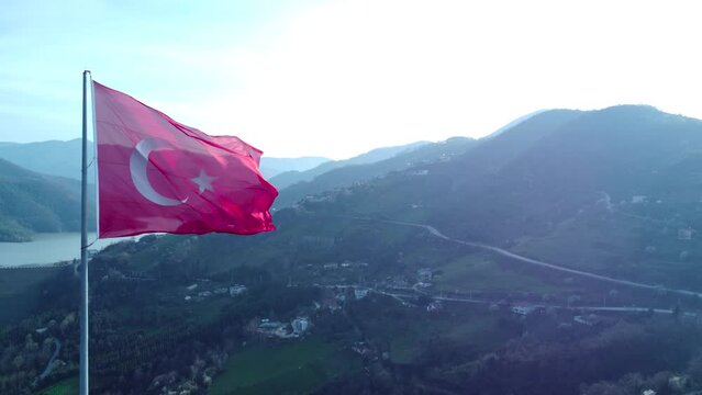 Turkish flag on top of the mountain. Turkish flag at the top with beautiful view. Turkish National holidays. 23 Nisan, 19 Mayis, 30 Agustos, 29 Ekim concept. Drone view. Aerial cinematic shot.