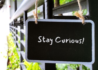 Chalkboard with handwritten text STAY CURIOUS - refers to desire to learn or know about anything,...